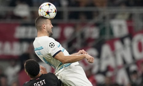 Mateo Kovacic heads the ball over Sergino Dest Milan