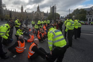 Insulate Britain activists artifact  Parliament Square aft  glueing their hands to the roadworthy  - portion  of ongoing protests to request  the authorities  speeds up   the process   of insulating British homes