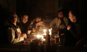 Residents play cards in Simferopol. Locals say supplies of candles and batteries have been exhausted.