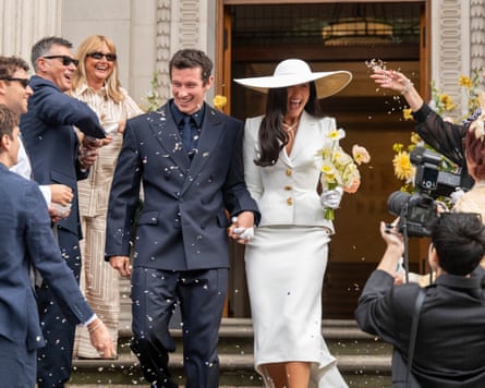 Callum Turner and Dua Lipa have confetti thrown at them as they leave register office