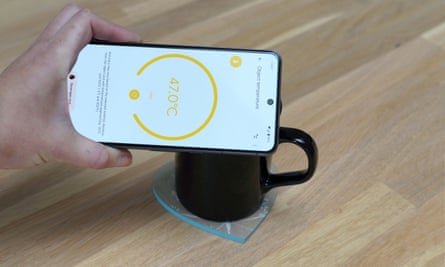 The Pixel 8 Pro taking the temperature of a cup of coffee.
