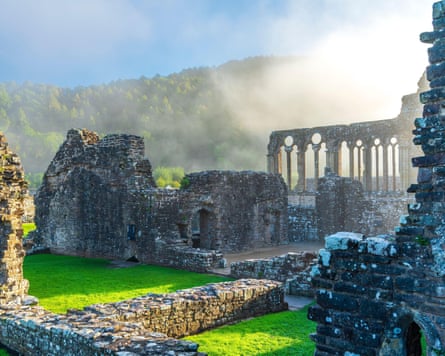 Abbey ruins shrouded in mist.