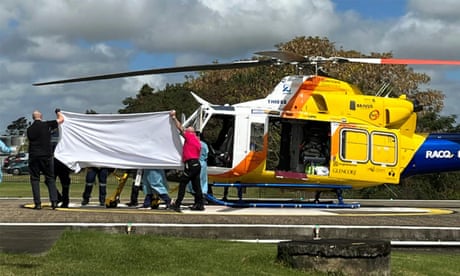 A patient is transported from a helicopter on the tarmac at Mackay base hospital