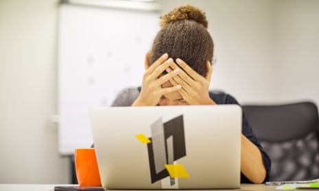 Woman at a laptop looking distressed