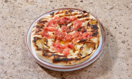 ‘On the grill it has bulged and expanded, blistered and broken’: flatbread with tomato.