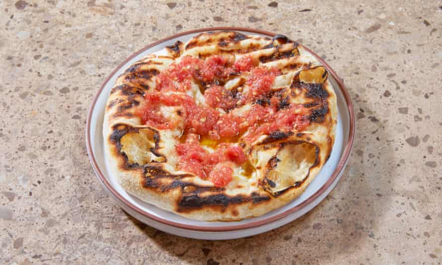 ‘On the grill it has bulged and expanded, blistered and broken’: flatbread with tomato.