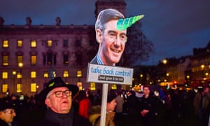 An anti-Brexit protester with a placard of Jacob Rees-Mogg, London, January 2019