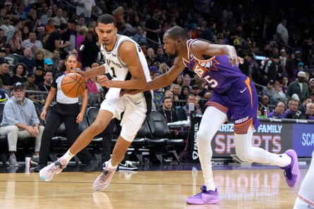 San Antonio midfielder Victor Wimpanyama collides with Phoenix forward Kevin Durant during the second half of Thursday's game.