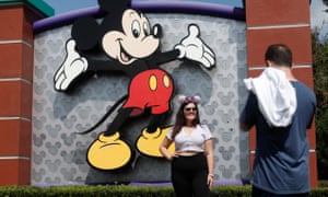 Visitors taking pictures outside the entrance to Disney World in Florida, which is set to reopen this weekend.