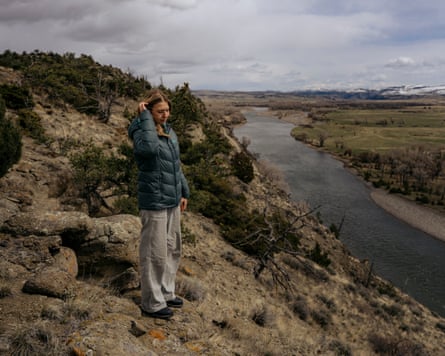A woman poses on a hiking trail