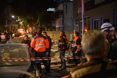 Emergency workers respond to a ballistic missile attack in Tel Aviv in which a couple in their 70s were killed
