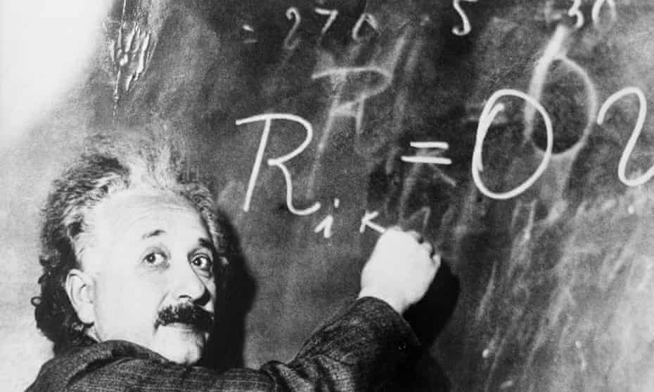 Albert Einstein writes a complicated equation on a blackboard. He is at the California Institute of Technology for a lecture being given by Swedish astronomer Dr. Gustave Stromberg.