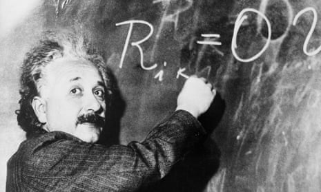 Einstein writes on blackboard