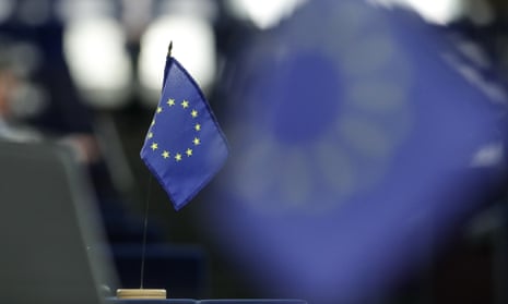 An EU flag on a desk in the European parliament.