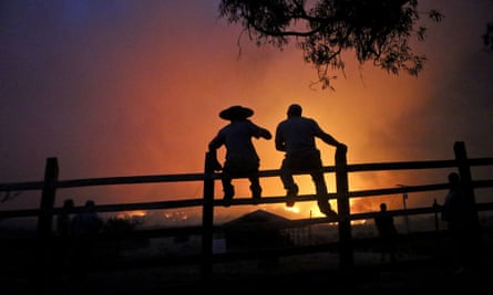 Residents watch the forest burn in Portezuelo on 29 January.