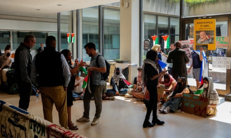 Columbia staff and security speak to pro-Palestinian students who are performing a sit-in