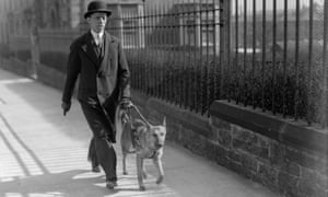 MP Andrew Gilzean is guided through the streets of Edinburgh by his Alsatian guide dog Lady, April 1935.