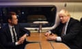 Andy Street sitting at a train carriage table with Boris Johnson