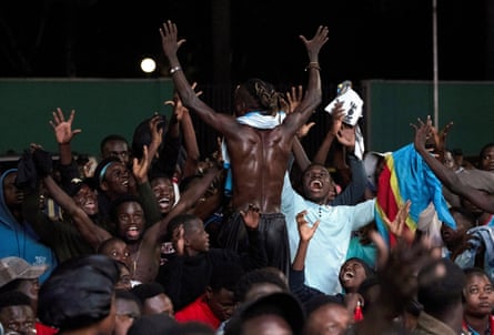 DRC fans react as they watch the match in Kinshasa.