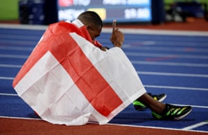 England’s Zharnel Hughes celebrates after winning silver in the men’s 200m final