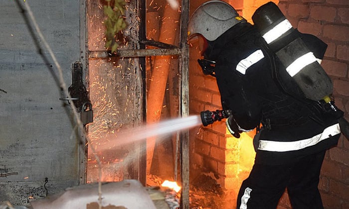 A firefighter fights a blaze in Mykolaiv after shelling in the port city