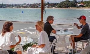 Customers enjoy a coffee at a cafe in Auckland after emerging from a long lockdown.