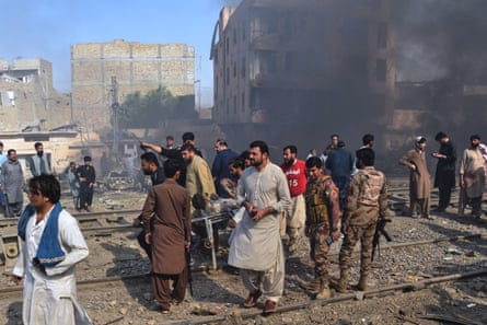 Paramilitary soldiers and volunteers transport an injured victim at the site of explosion in Quetta, Pakistan.