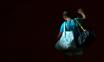 Rafael Nadal waves as he leaves court.