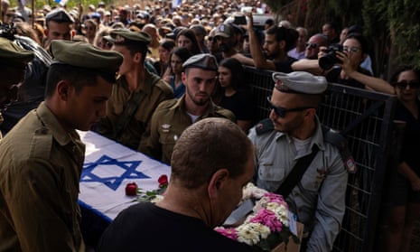 Israeli soldiers carry a coffin draped with the Israeli flag during the funeral of Dana Bachar and her son Carmel.