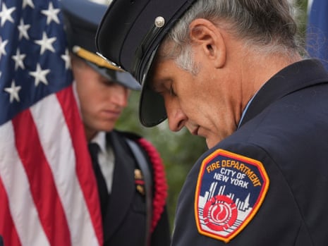 Retired New York City firefighter Paul Matulis, right, and Austin firefighter Matthew Boyan of the Austin Fire Department Honor Guard pray during a 9/11 Memorial at the Buford Fire Tower in Austin, Texas.