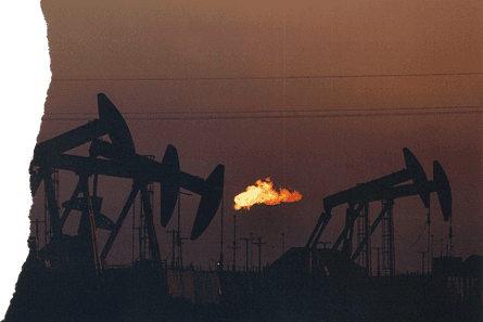 A flare burns off methane and other hydrocarbons as oil pumpjacks operate
