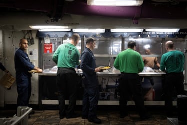 Sailors line up for a meal.