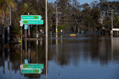 Shepparton streets flooded with water with only road signs and trees visible