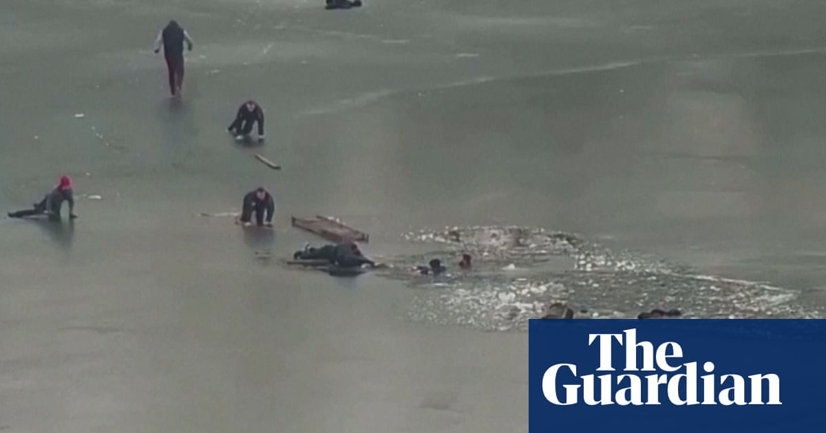 Ukraine: dramatic footage shows police save four men who fell into icy water – video