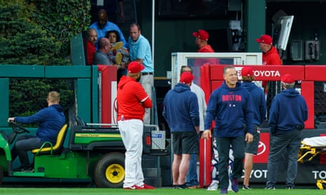 A fan, who fell into the Boston Red Sox bullpen, is brought down by the medical staff during the first inning of a baseball game against the Philadelphia Phillies on Friday.