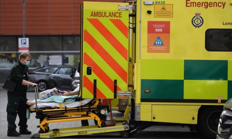 A paramedic wheeling someone on a stretcher out of an ambulance