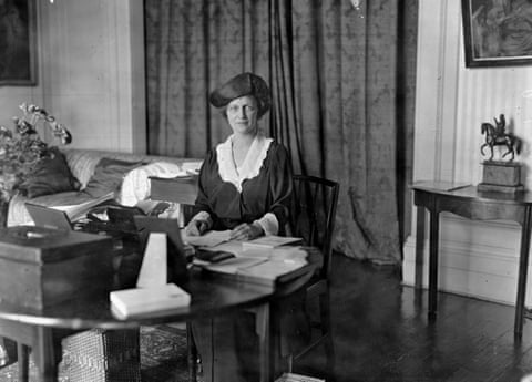 Nancy Astor at her desk, in black suit and white blouse