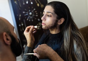 Zeinab uses makeup to disguise herself as a man.