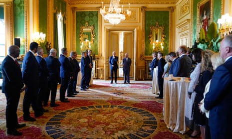 King Charles and US president Joe Biden arrive to meet participants of the climate finance mobilisation forum in the green drawing room at Windsor Castle.