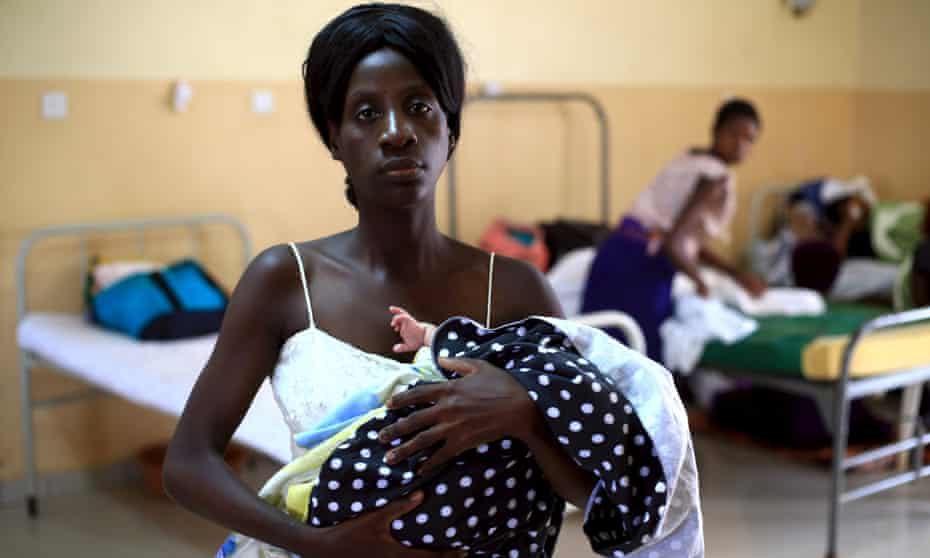 A mother holds her baby at Kisenyi health centre