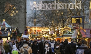 A crowd of people enjoy the Christmas market in Dortmund, Germany, 1 December, as the country recorded another 388 deaths on Wednesday.