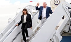 Kamala Harris and a waving Tim Walz exit an airplane at Savannah/Hilton Head International Airport in Savannah, Georgia.