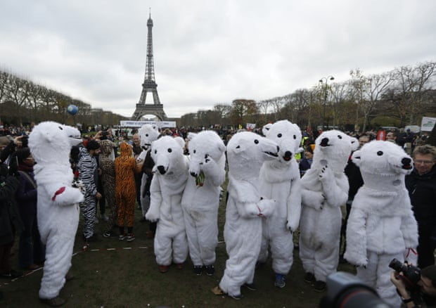 People dressed as polar bears demonstrate near the Eiffel Tower in Paris, during COP21.