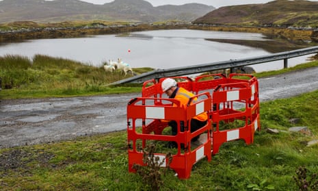 An engineer works on a full fibre broadband link on Grimsay in the Outer Hebrides of Scotland.