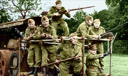 Clive Dunn, John Le Mesurier, Ian Lavender, John Laurie, Arthur Lowe, James Beck & Arnold Ridley in still from 1973: they are all in khaki uniform and brandishing rifles, brooms, a pitchfork and farm equipment
