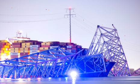 The Francis Scott Key Bridge rests partially collapsed after a container ship ran into it in Baltimore