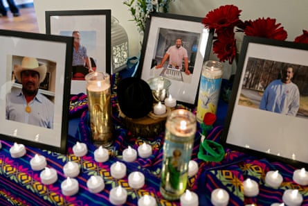 framed photos of a man sit on table beside candles