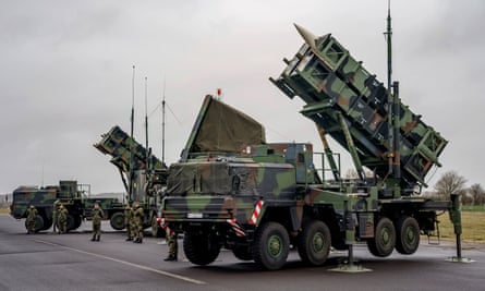 A military vehicle and weapons in an airfield
