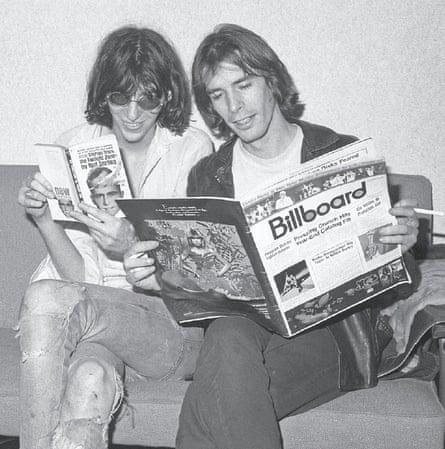 two men reading a magazine