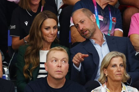 Royals William (pointing) and Catherine behind Sophie, Duchess of Edinburgh and Chris Hoy in the stands at the Commonwealth Games cycling veledrome